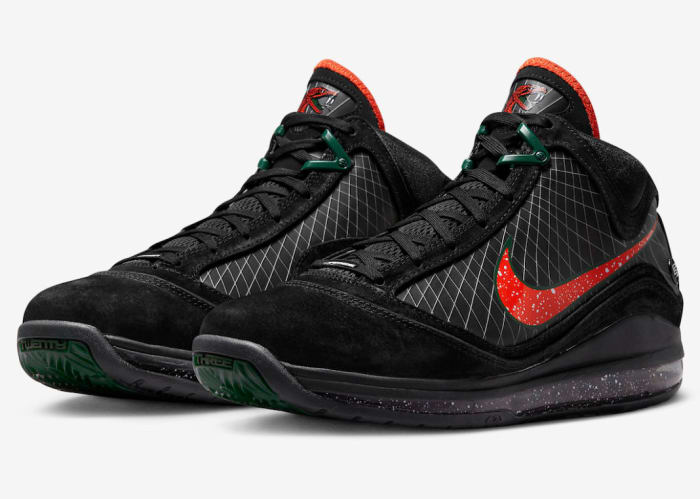 Side view of LeBron James' black, orange, and green Nike shoes.